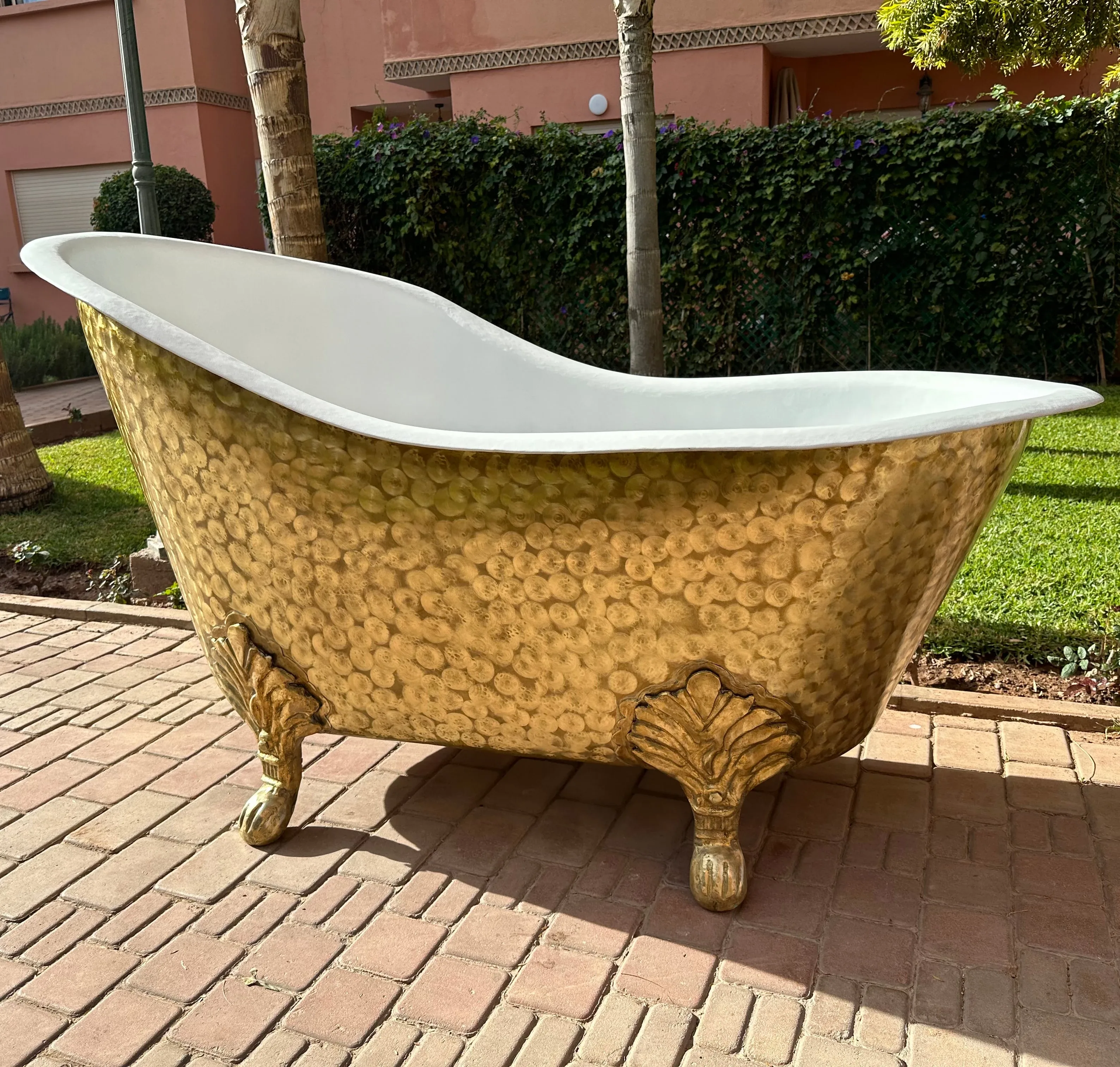 Brass sculptural objects beside a curved sofa