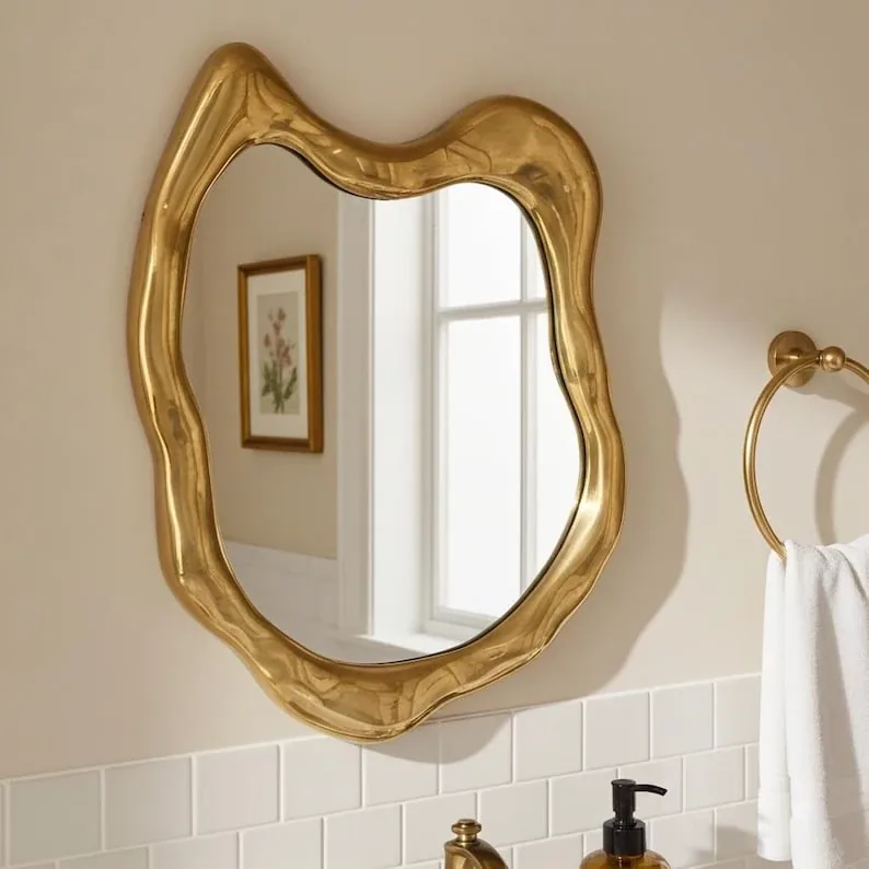 Brass sculptural objects beside a curved sofa